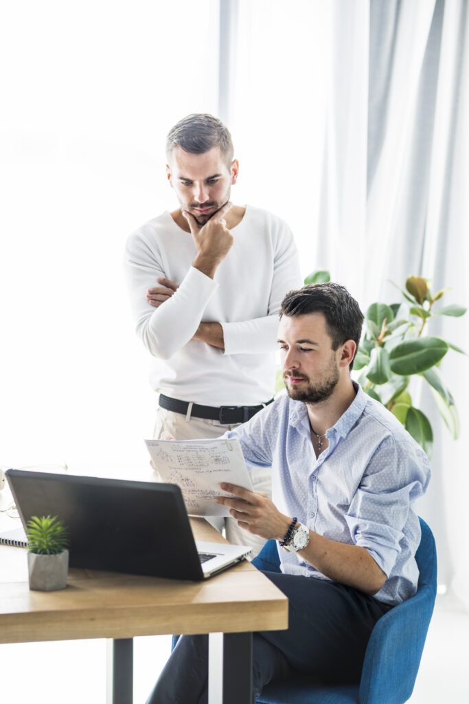 two male businessmen working office